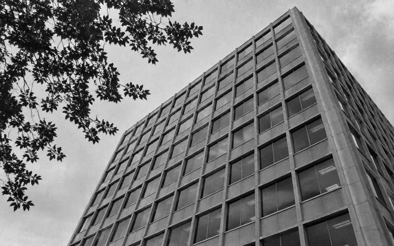 Modernist office building facade seen from below